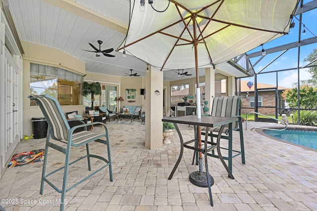 view of patio featuring a lanai and ceiling fan