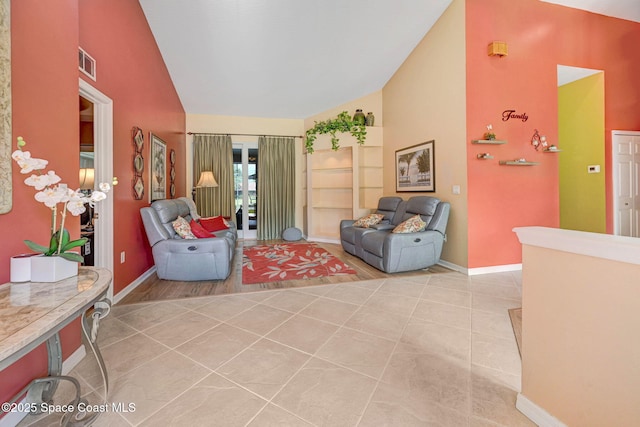 living area with light tile patterned flooring and lofted ceiling