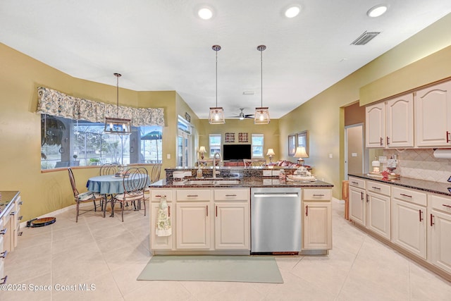 kitchen with dishwasher, decorative light fixtures, dark stone countertops, tasteful backsplash, and sink