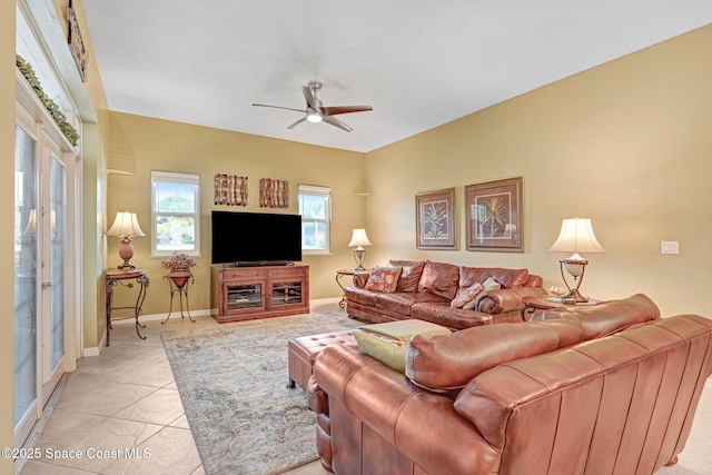 living room featuring ceiling fan and light tile patterned floors