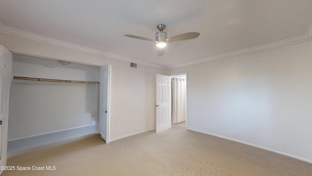 unfurnished bedroom with ceiling fan, a closet, and crown molding