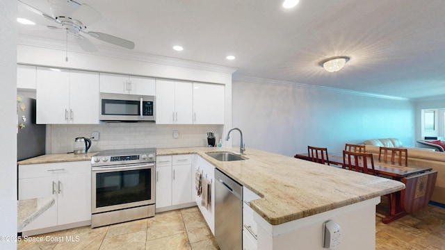 kitchen featuring white cabinetry, stainless steel appliances, kitchen peninsula, and sink