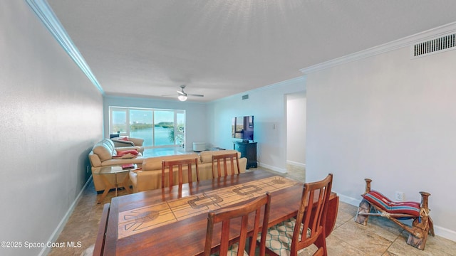 dining space featuring ceiling fan and crown molding