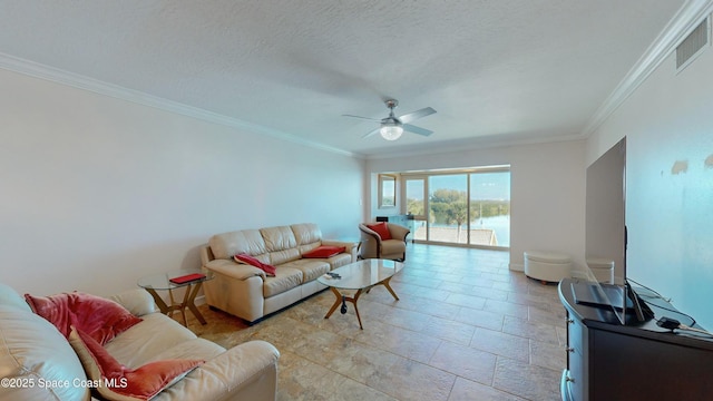 living room featuring a textured ceiling, ceiling fan, and ornamental molding