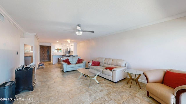 living room featuring ceiling fan and ornamental molding