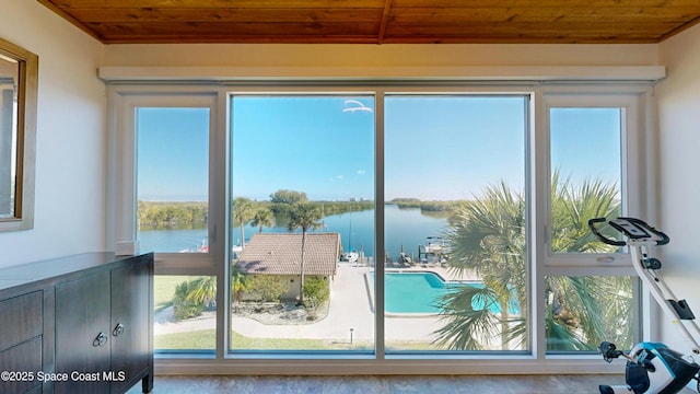 entryway featuring a water view, plenty of natural light, and wooden ceiling