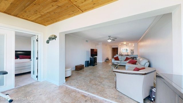 living room with ceiling fan, wood ceiling, and crown molding