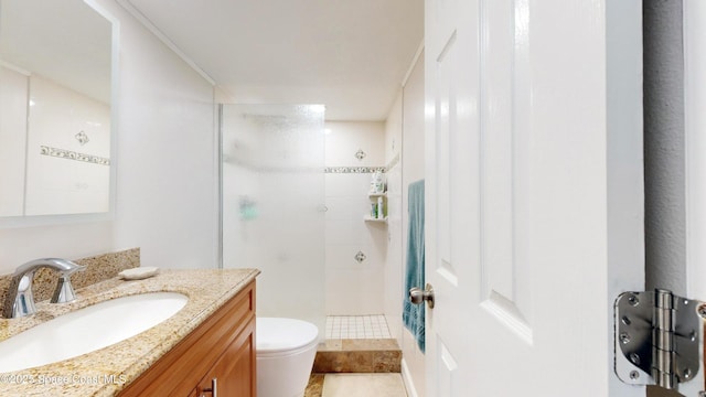 bathroom featuring tiled shower, vanity, toilet, and tile patterned flooring