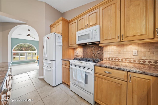 kitchen featuring white appliances, ceiling fan, light tile patterned floors, tasteful backsplash, and stone countertops