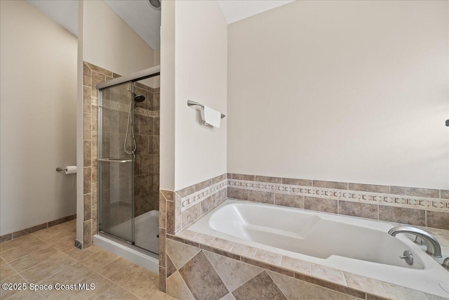 bathroom featuring tile patterned flooring and independent shower and bath