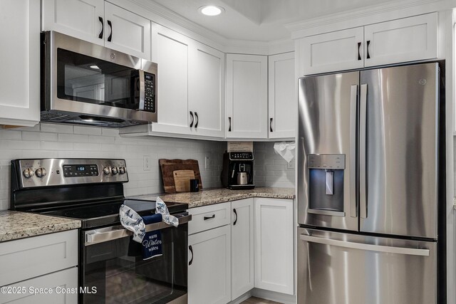 kitchen featuring white cabinetry and appliances with stainless steel finishes