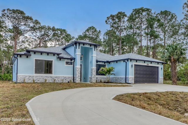 view of front of home featuring a garage and a front yard