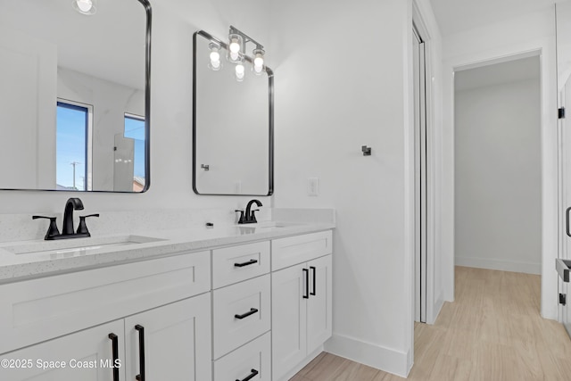 bathroom featuring hardwood / wood-style flooring and vanity