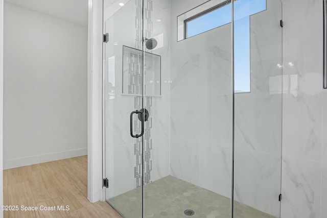 bathroom with a shower with door