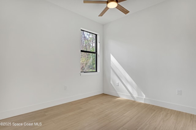 spare room featuring light hardwood / wood-style floors and ceiling fan