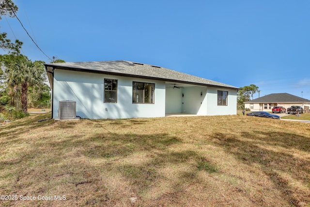 back of house with a yard, central AC, and ceiling fan