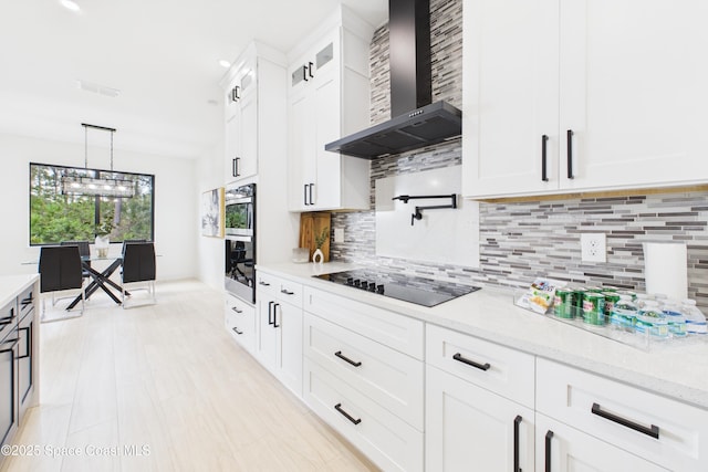 2311 San Filippo Dr SE, Palm Bay, FL 32909 - kitchen with black electric cooktop, decorative backsplash, white cabinets, glass insert cabinets, and wall chimney exhaust hood