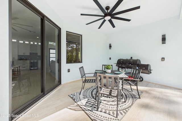 2311 San Filippo Dr SE, Palm Bay, FL 32909 - dining room with ceiling fan, wine cooler, and light wood-style floors