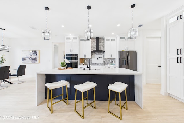 2311 San Filippo Dr SE, Palm Bay, FL 32909 - kitchen featuring light countertops, stainless steel appliances, tasteful backsplash, wall chimney range hood, and a notable chandelier