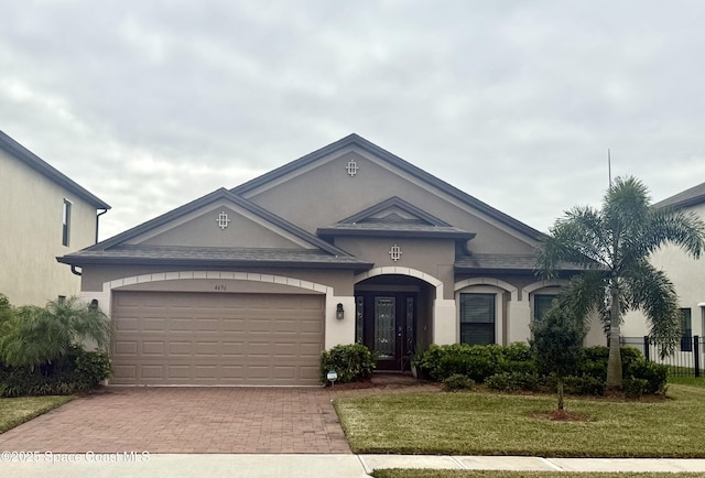 view of front of house with a front lawn and a garage