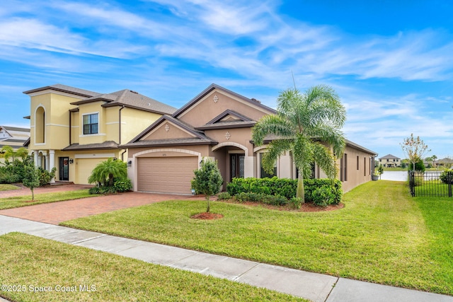 view of front of property with a garage and a front yard