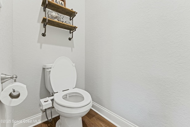 bathroom with toilet and wood-type flooring