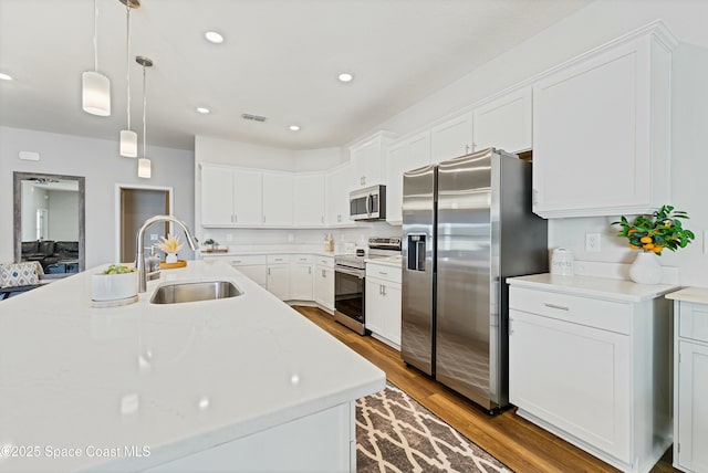 kitchen with sink, white cabinetry, and appliances with stainless steel finishes