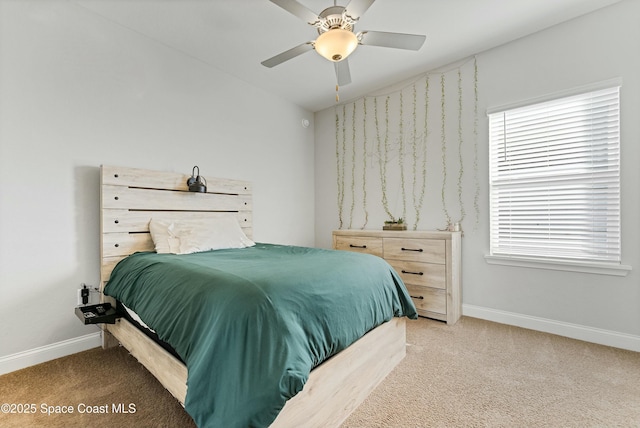 bedroom featuring ceiling fan, multiple windows, and carpet