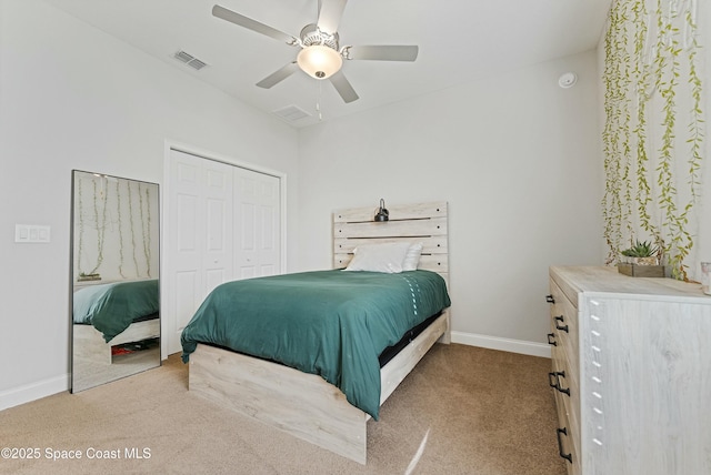 bedroom featuring ceiling fan, a closet, and light carpet