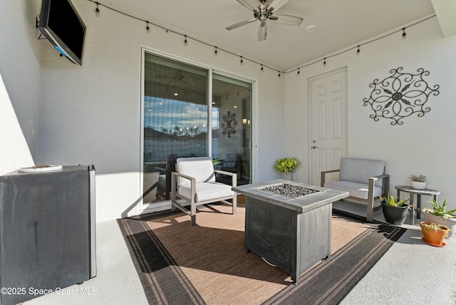 view of patio / terrace with an outdoor living space with a fire pit and ceiling fan