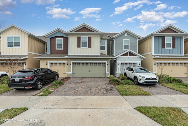 townhome / multi-family property featuring a garage