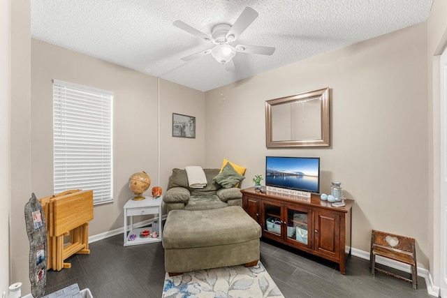 sitting room with a textured ceiling and ceiling fan