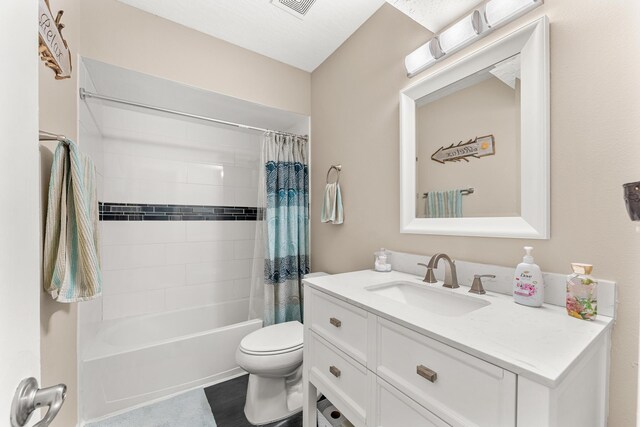 full bathroom with shower / bath combination with curtain, vanity, and toilet