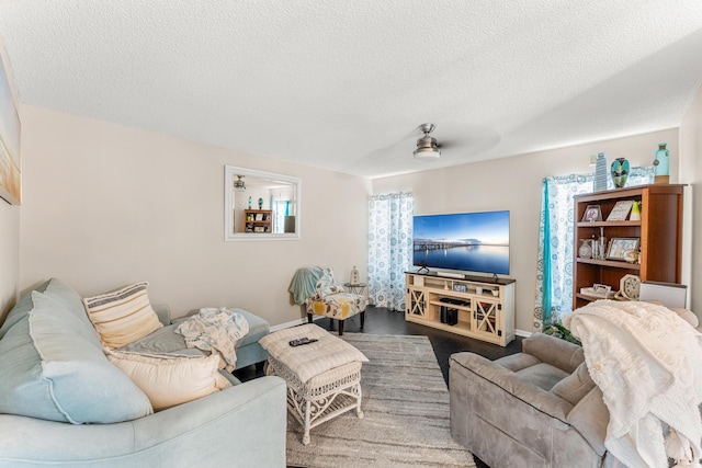 living room featuring a textured ceiling and ceiling fan