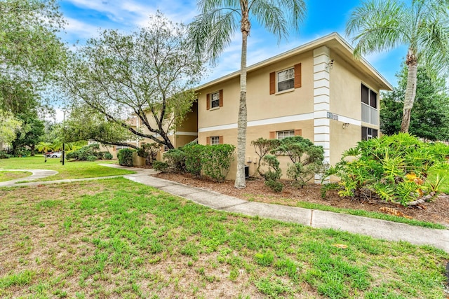 view of side of property with a yard