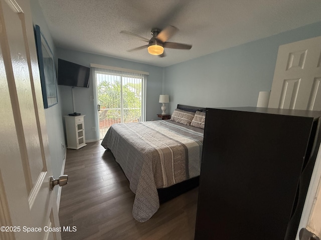 bedroom featuring dark wood-style flooring, a textured ceiling, access to outside, and a ceiling fan