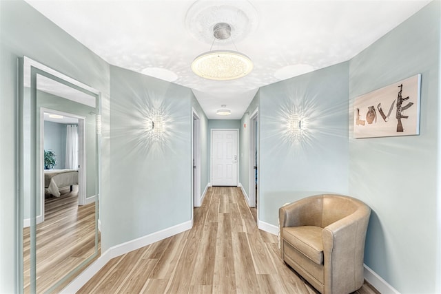 hallway with a textured ceiling and light wood-type flooring