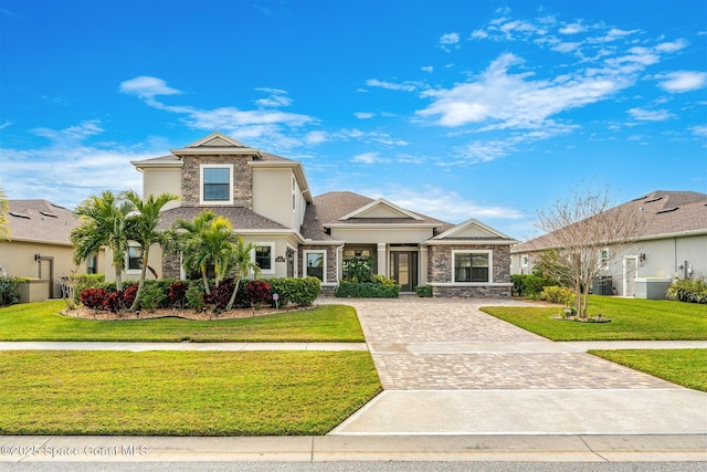 view of front of home featuring central AC and a front yard