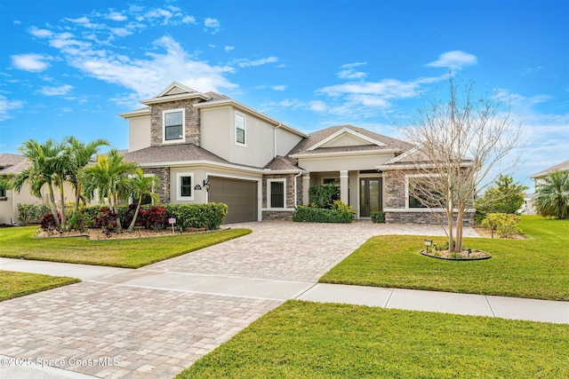 view of front of property featuring a garage and a front lawn