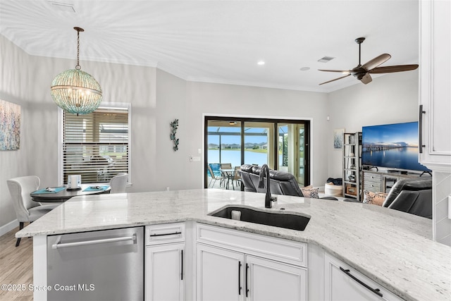 kitchen featuring white cabinets, dishwasher, light stone countertops, and sink