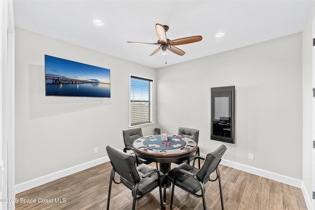 dining area with hardwood / wood-style flooring and ceiling fan