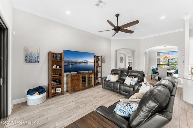 living room with crown molding, light hardwood / wood-style flooring, and ceiling fan