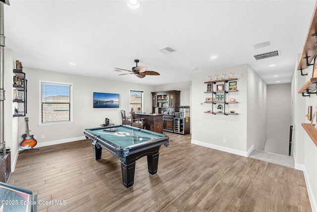 playroom featuring a textured ceiling, indoor bar, ceiling fan, billiards, and hardwood / wood-style flooring