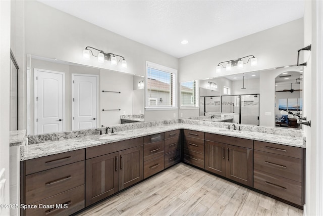 bathroom with vanity, hardwood / wood-style flooring, and walk in shower