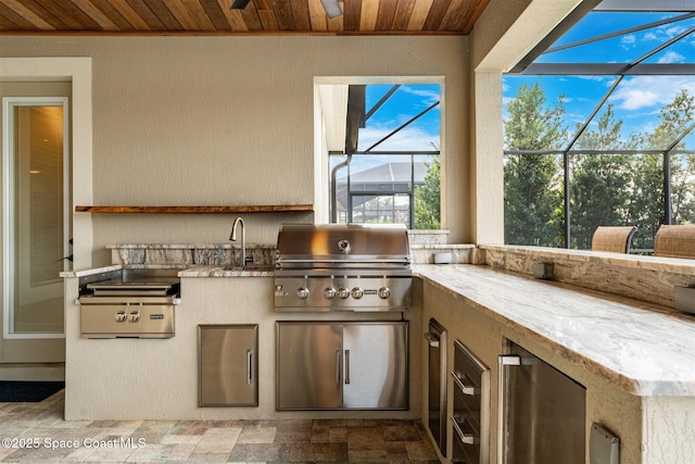 view of patio featuring exterior kitchen, sink, and area for grilling