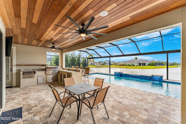 view of patio / terrace with area for grilling, pool water feature, glass enclosure, and ceiling fan