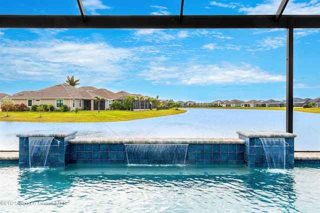 view of swimming pool featuring glass enclosure, a lawn, a water view, and pool water feature