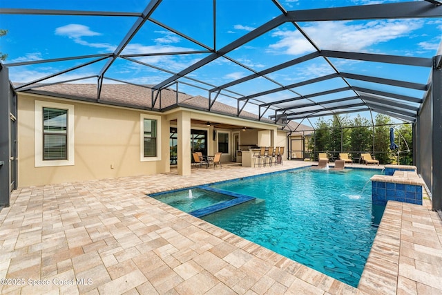 view of swimming pool with a patio area, an in ground hot tub, an outdoor bar, a lanai, and pool water feature