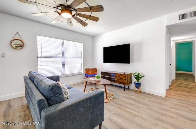 living room featuring light wood-type flooring and ceiling fan