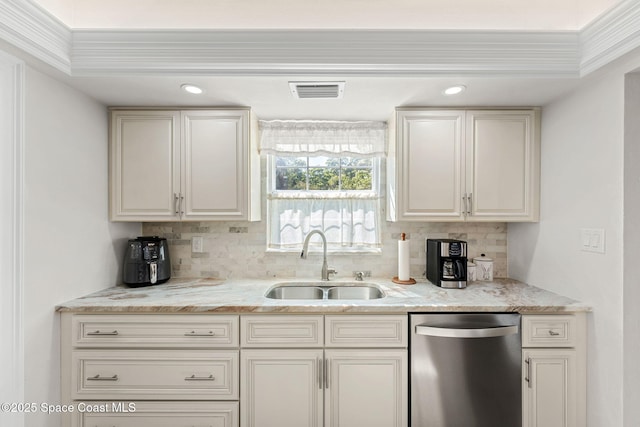 kitchen featuring light stone counters, visible vents, backsplash, stainless steel dishwasher, and a sink